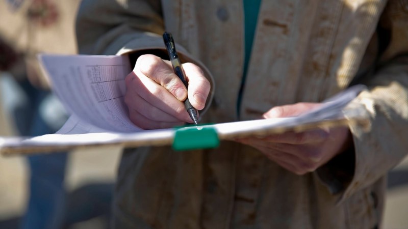 A voter signs the 2022's 'Raise the Wage Nebraska' ballot petition. (Photo Courtesy: Raise the Wage Nebraska)