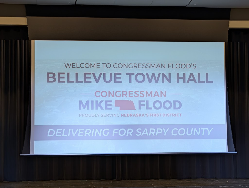 The power point projector slide present throughout Nebraska Rep. Mike Flood's town hall in Bellevue, Nebraska, hosted on Tuesday, June 9, 2026. | Photo: Chase Porter/Courier Nebraska