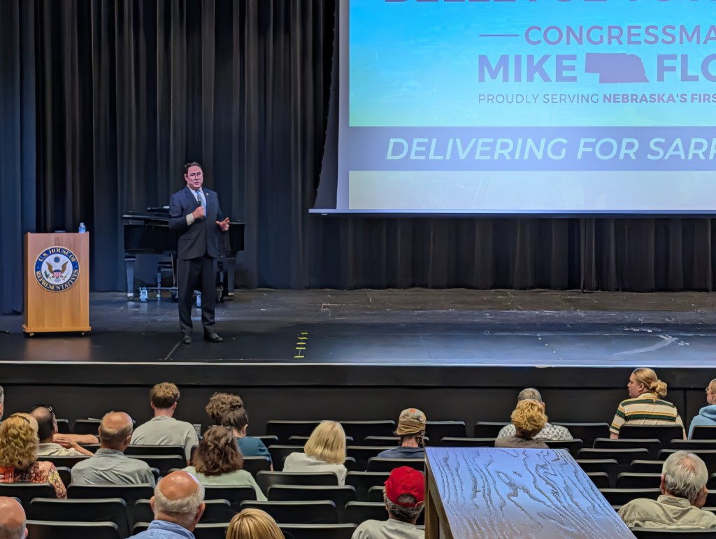 Nebraska 1st District Rep. Mike Flood stands before the crowd during a public town hall event hosted in Bellevue, Nebraska, on Tuesday, June 7, 2026. | Photo: Chase Porter/Courier Nebraska