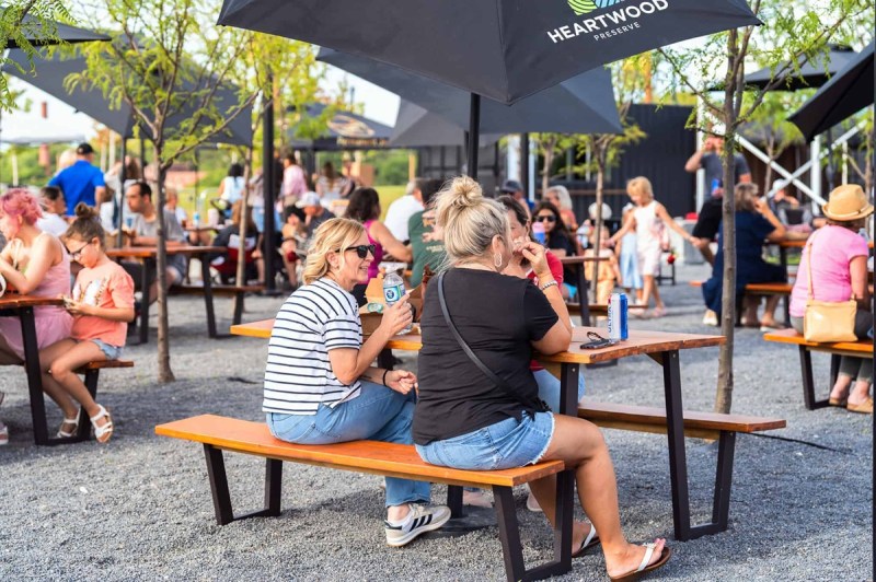 Two women sit outside at one of many farmers markets in Nebraska