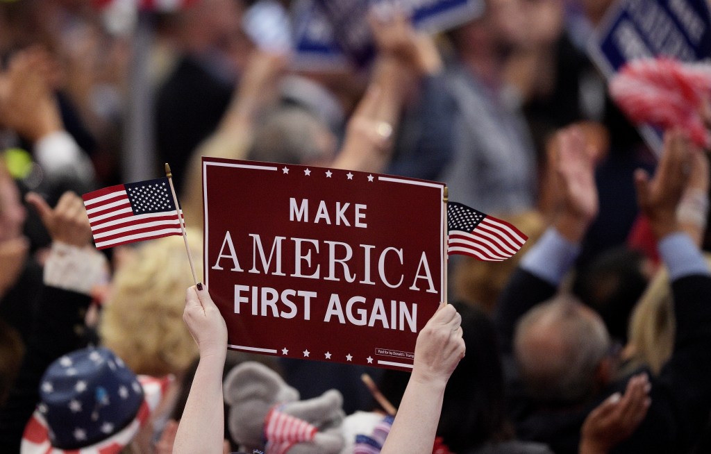 CLEVELAND, OH - JULY 20: A delegates holds up signs that read "Make America First Again" during the opening of the third day of the Republican National Convention on July 20, 2016 at the Quicken Loans Arena in Cleveland, Ohio. Republican presidential candidate Donald Trump received the number of votes needed to secure the party's nomination. An estimated 50,000 people are expected in Cleveland, including hundreds of protesters and members of the media. The four-day Republican National Convention kicked off on July 18. (Photo by Jeff Swensen/Getty Images)