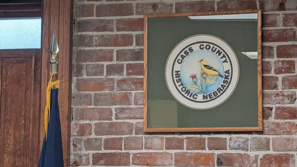A Cass County seal overlooks the board of commissioner's hearing room. | Photo:  Chase Porter/Courier Nebraska 