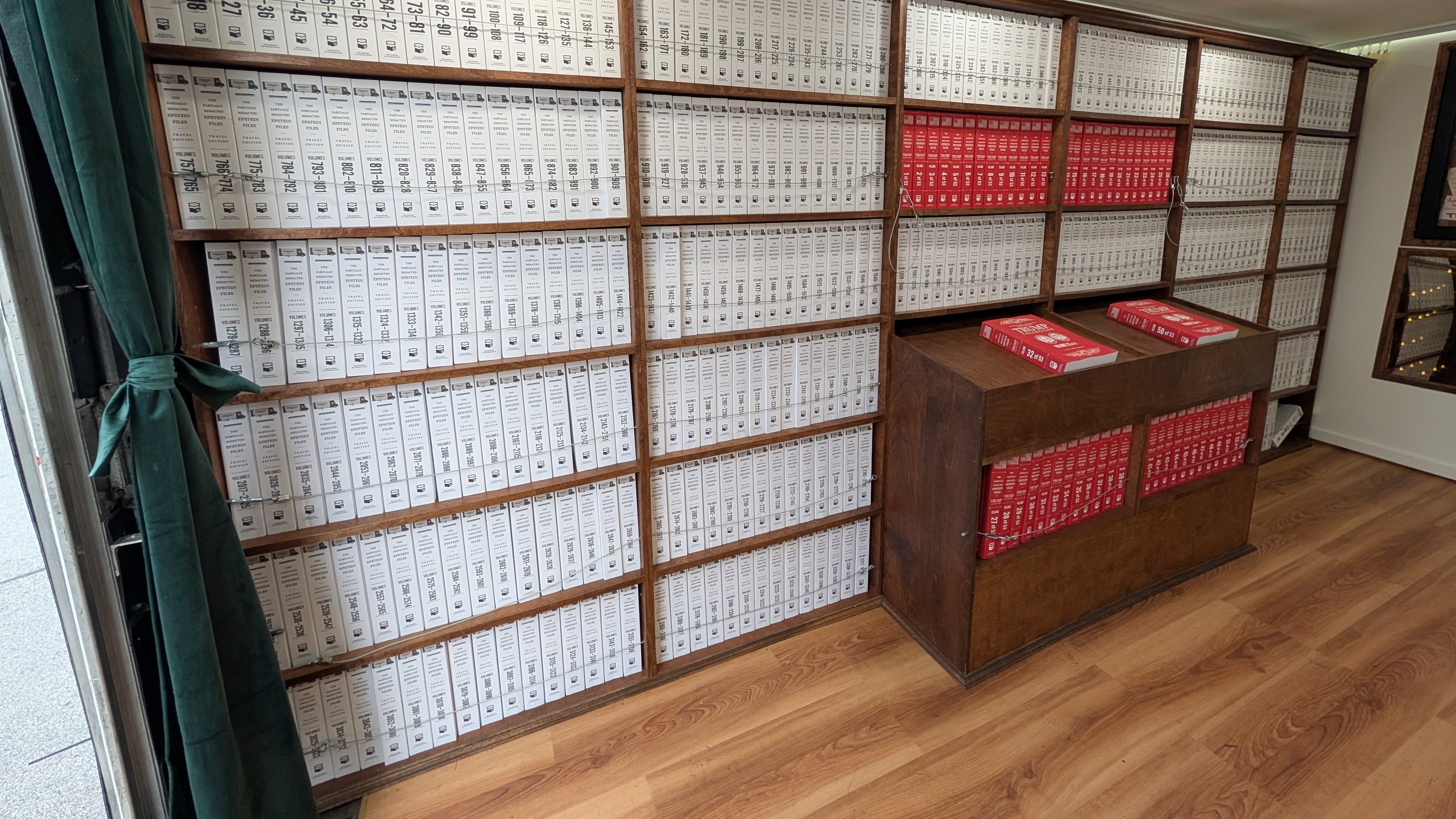 Rows of book bound public documents relating to the investigation of Jeffrey Epstein's massive trafficking operation sit in the  "Donald J. Trump and Jeffrey Epstein Memorial Bookmobile" during its Omaha stop on Sunday, Sept. 13, 2026. | Photo: Chase Porter/Courier Nebraska