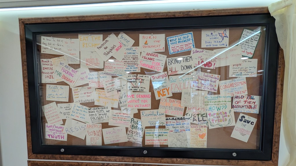 Hand made notes sit encased inside the "Donald J. Trump and Jeffrey Epstein Memorial Bookmobile" during its stop in Omaha, Nebraska, on Sunday, Sept. 13, 2026. | Photo: Chase Porter/Courier Nebraska