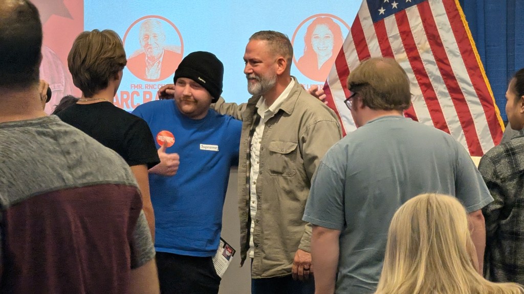 Dan Osborn, an independent candidate for US Senate in Nebraska, poses for a photo with an attendee after a “cross-party” town hall for his campaign in Omaha, Neb., on Saturday, Oct. 24. Photo: Chase Porter/Courier Nebraska.