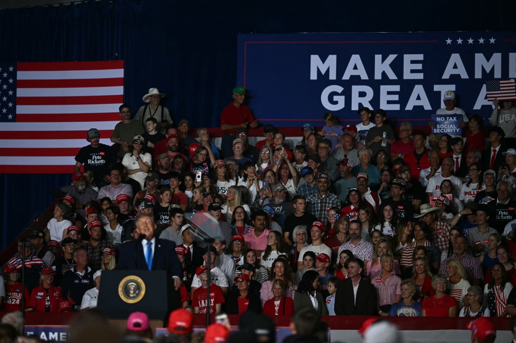 Supporters watch US President Donald Trump speak during a campaign rally at Pinnacle Bank Expo Center in Grand Island, Nebraska, on October 5, 2026. (Photo by Kent NISHIMURA / AFP via Getty Images)
