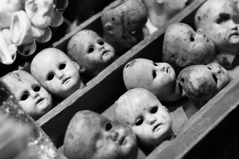 A drawer full of creepy doll heads